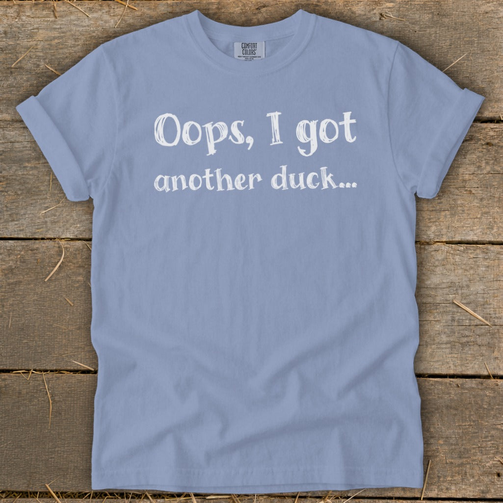 Light blue t-shirt with white text that reads "Oops, I got another duck..."