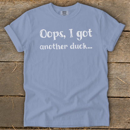 Light blue t-shirt with white text that reads "Oops, I got another duck..."