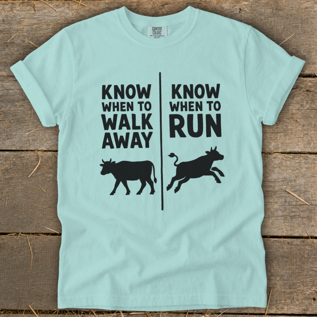 Light blue t-shirt with "Know When To Walk Away" and "Know When To Run" text and cow illustrations.