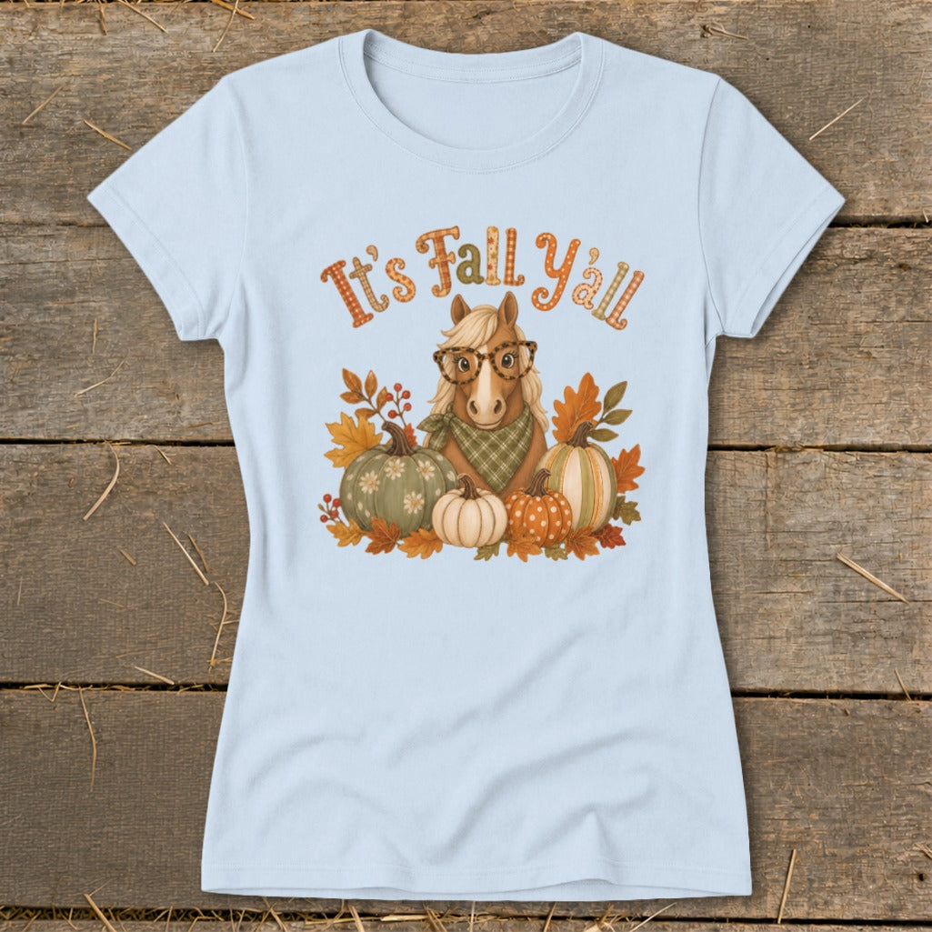 Light blue t-shirt with a horse wearing glasses, pumpkins, and leaves, reads "It's Fall Y'all".