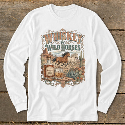 Whiskey & Wild Horses graphic on a white long-sleeve shirt with a desert scene.