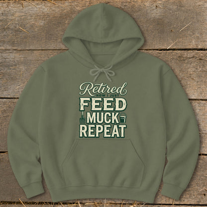 Olive green hoodie with "Retired Now I Just Feed Muck Repeat" graphic.