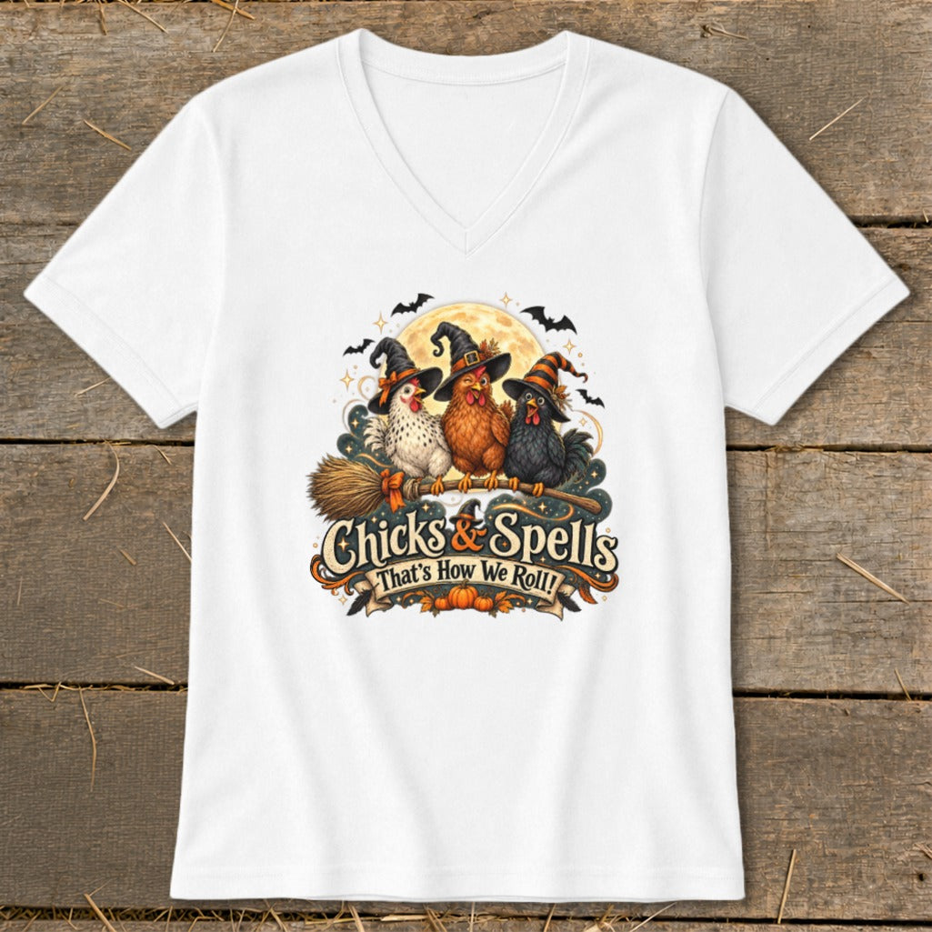 Three chickens wearing witch hats ride a broomstick, with text "Chicks & Spells That's How We Roll!".