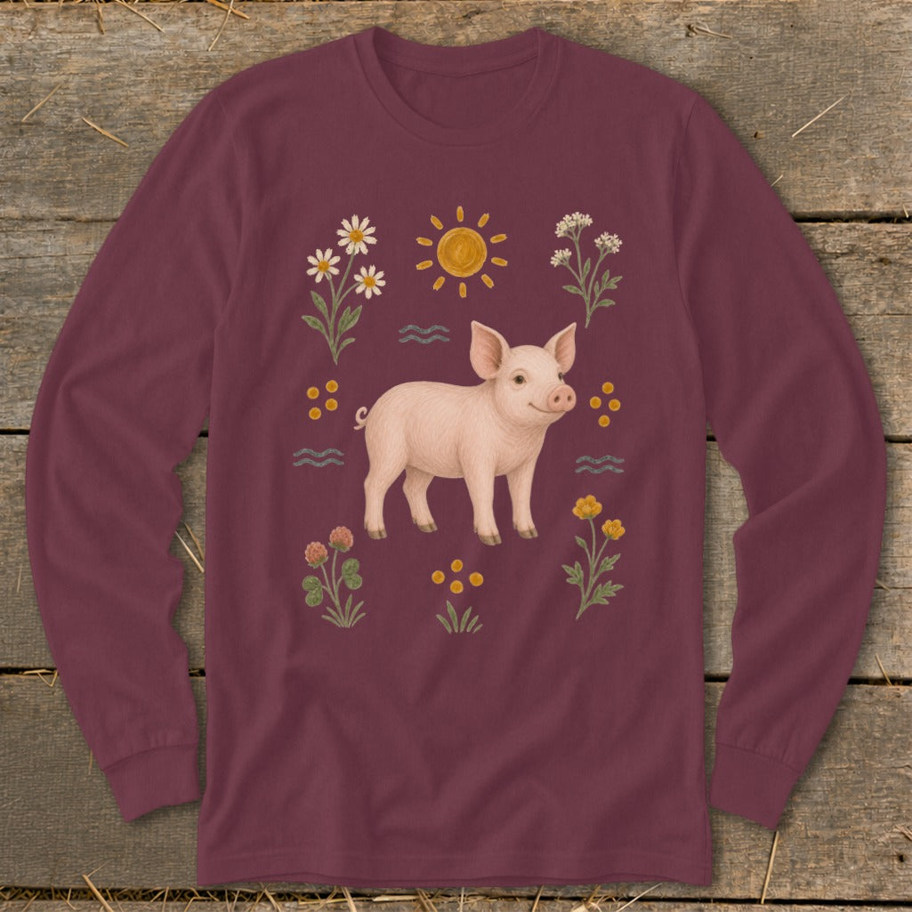 Burgundy long-sleeve shirt with a smiling pig surrounded by flowers and sun.