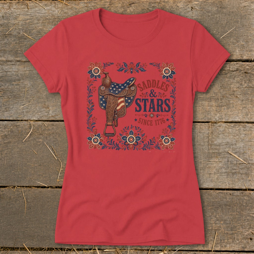 Red t-shirt with a western saddle graphic and "Saddles & Stars Since 1776" text.