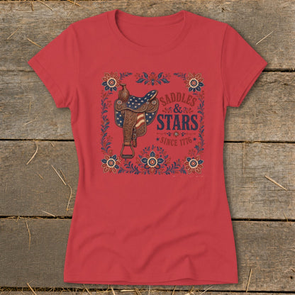 Red t-shirt with a western saddle graphic and "Saddles & Stars Since 1776" text.