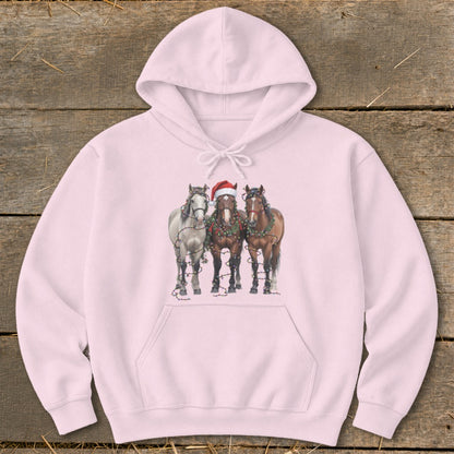 Three horses, one wearing a Santa hat, adorned with Christmas lights on a pink hoodie.