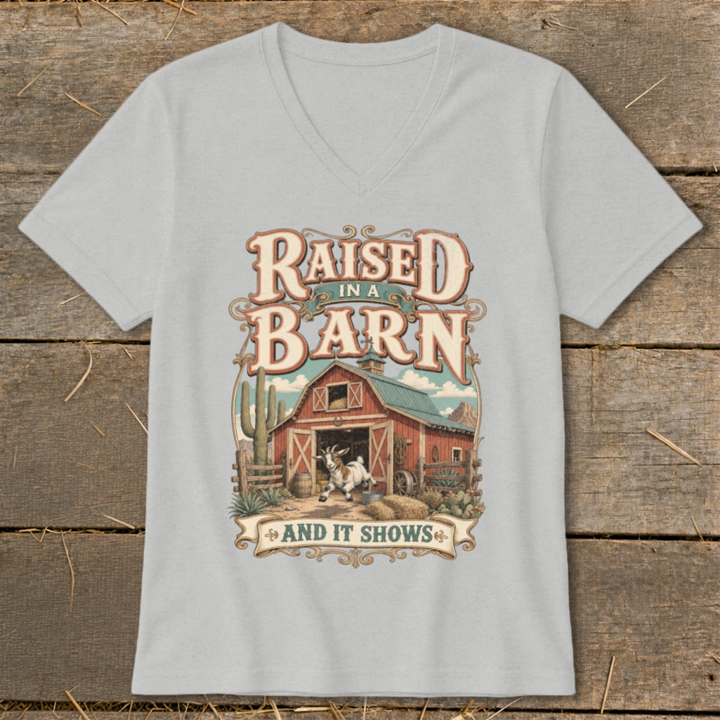 T-shirt graphic with text "Raised in a Barn And It Shows" and a goat at a barn.