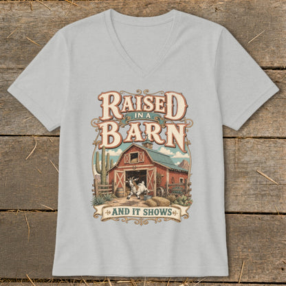 T-shirt graphic with text "Raised in a Barn And It Shows" and a goat at a barn.