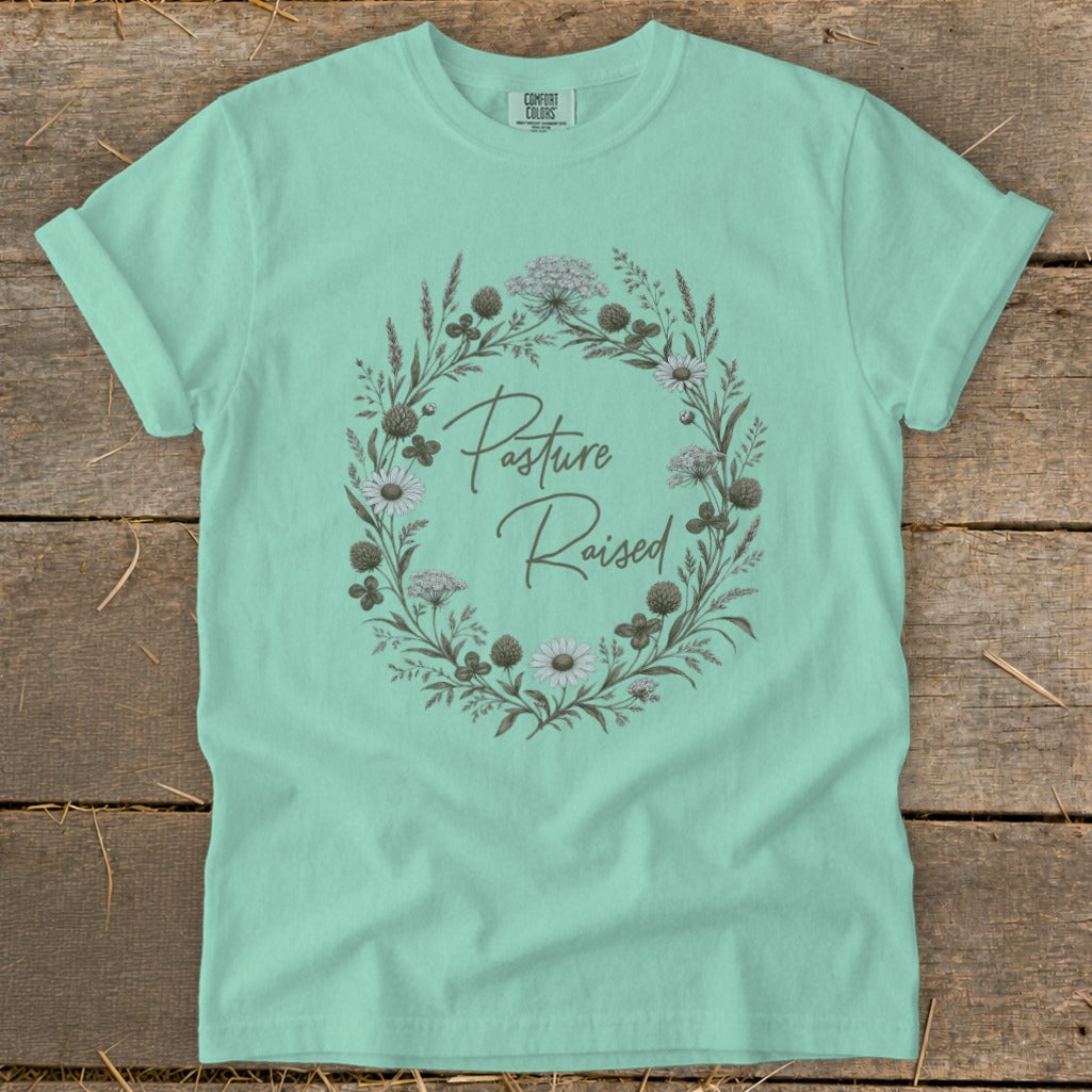 Mint t-shirt with a floral wreath graphic that reads "Pasture Raised."