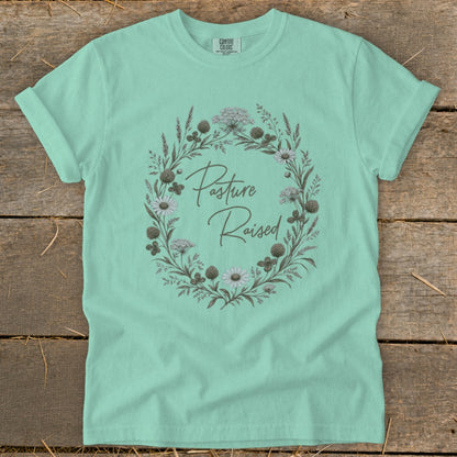 Mint t-shirt with a floral wreath graphic that reads "Pasture Raised."