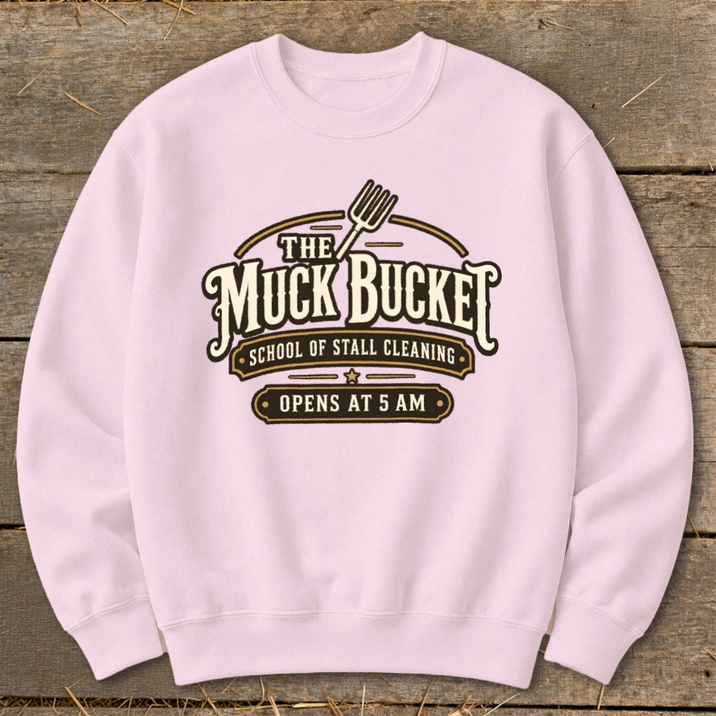 Light pink sweatshirt with "The Muck Bucket School of Stall Cleaning Opens at 5 AM" logo.