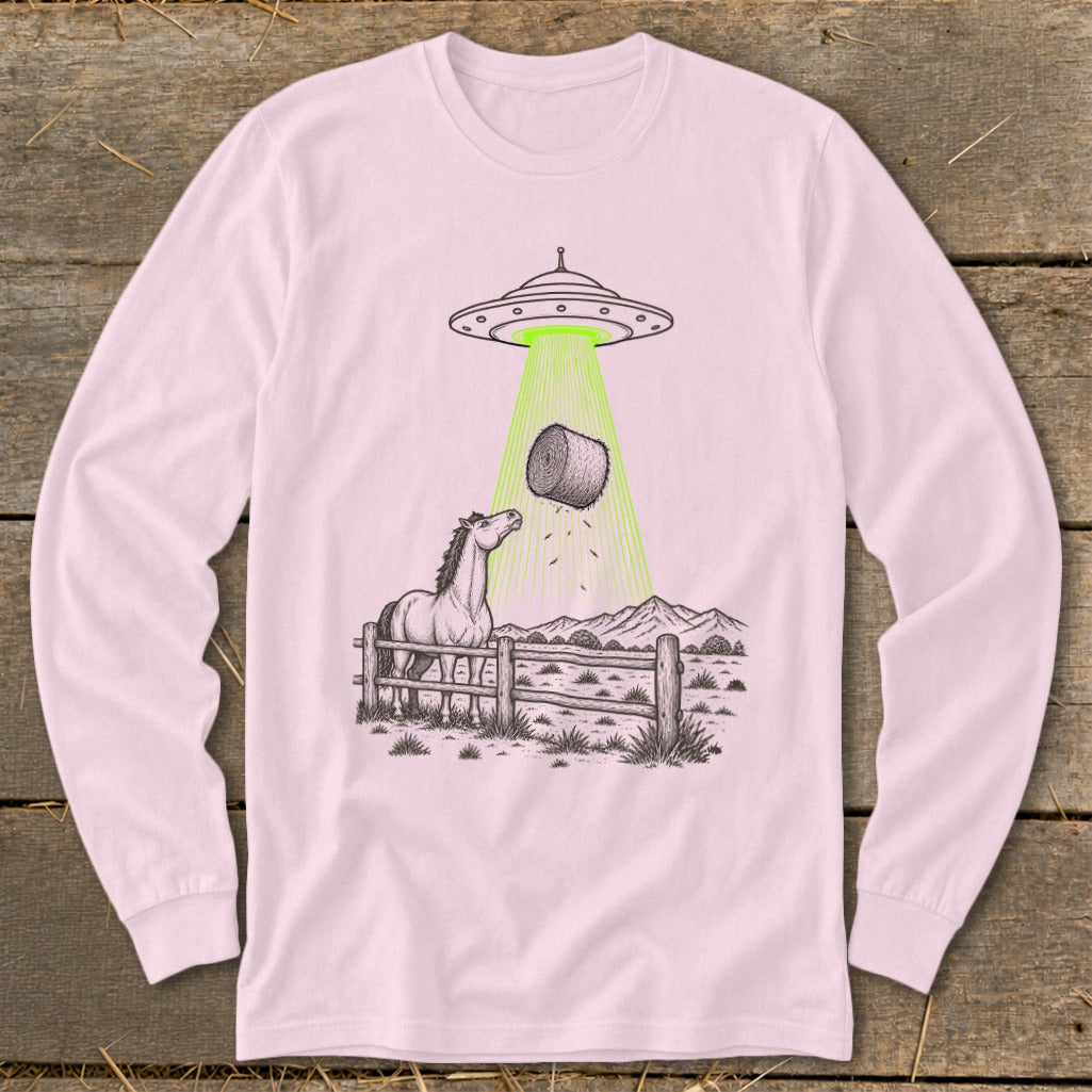 Horse and hay bale being abducted by a UFO in a rural landscape.
