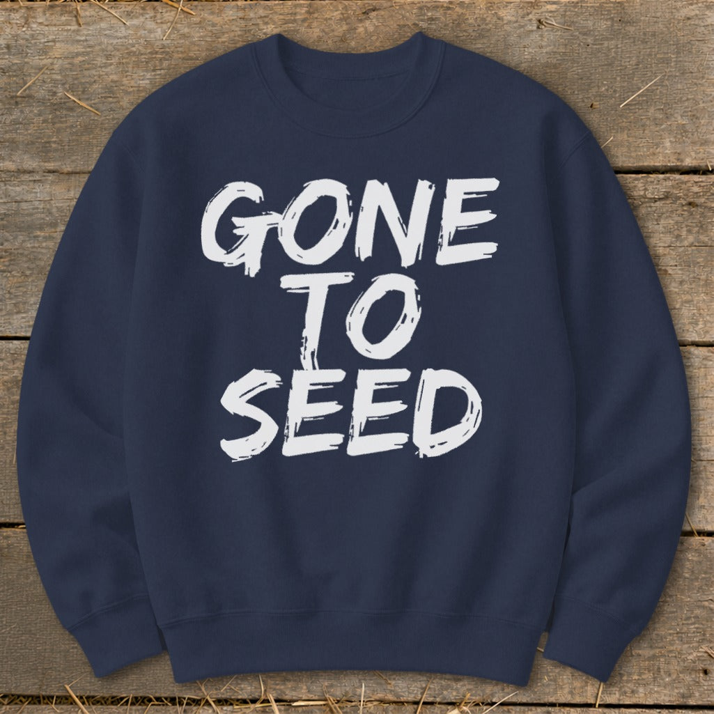 Navy sweatshirt with white "GONE TO SEED" text on distressed wood background.
