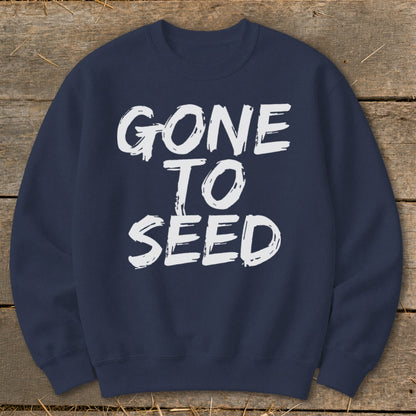 Navy sweatshirt with white "GONE TO SEED" text on distressed wood background.