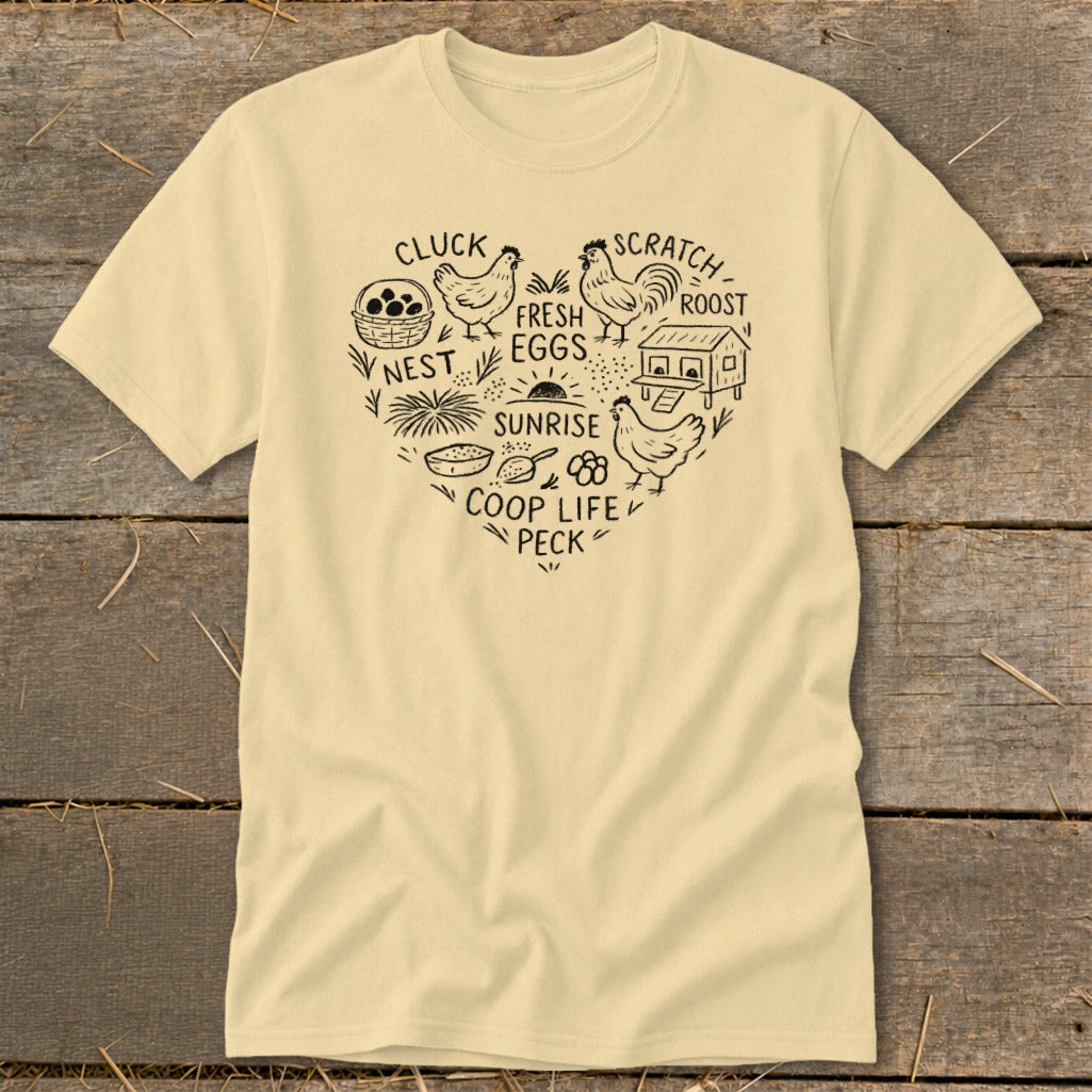 Cream t-shirt with heart-shaped chicken coop graphic and text: "Cluck, Nest, Sunrise, Coop Life, Peck, Scratch, Roost, Fresh Eggs."