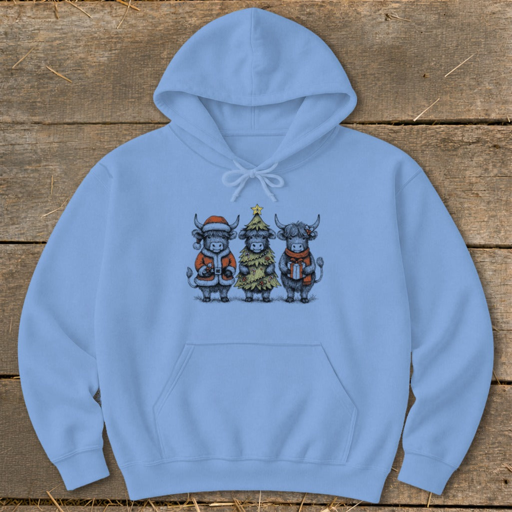 Light blue hoodie featuring three highland cows dressed for Christmas.