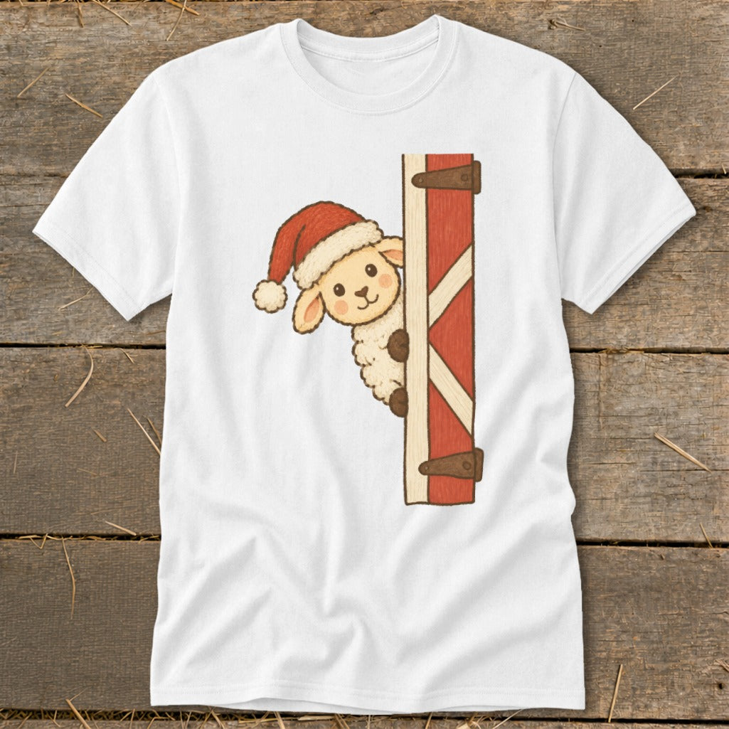 White t-shirt featuring a cartoon sheep wearing a Santa hat peeking around a red barn door.