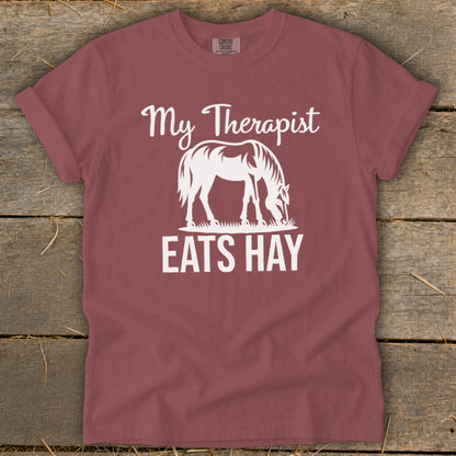 Maroon t-shirt with white text "My Therapist EATS HAY" and a horse graphic.