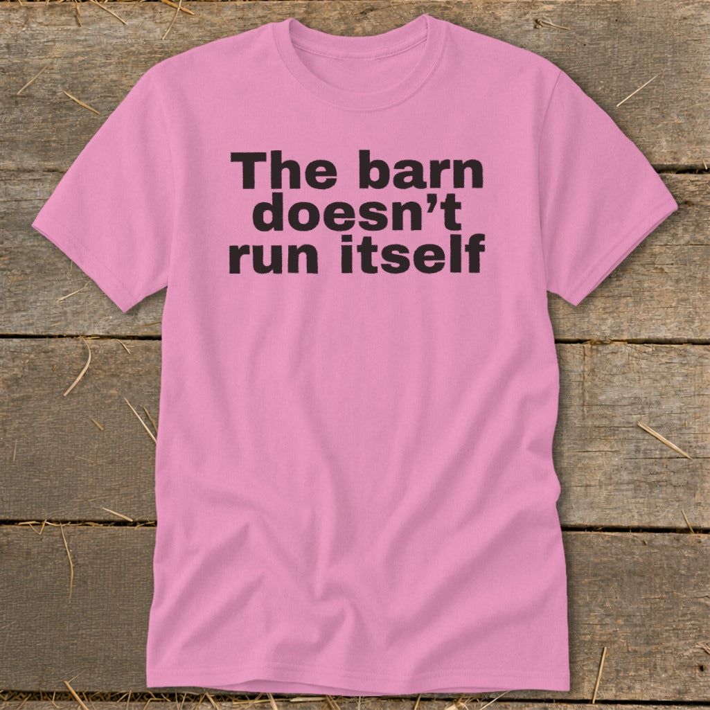 Pink t-shirt with black text reading "The barn doesn't run itself."