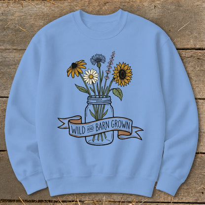 Light blue sweatshirt with a jar of wildflowers and the text "WILD AND BARN GROWN".
