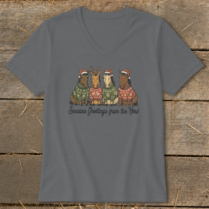 Four horses wearing Santa hats and festive sweaters, with text "Seasons Greetings from the Herd".