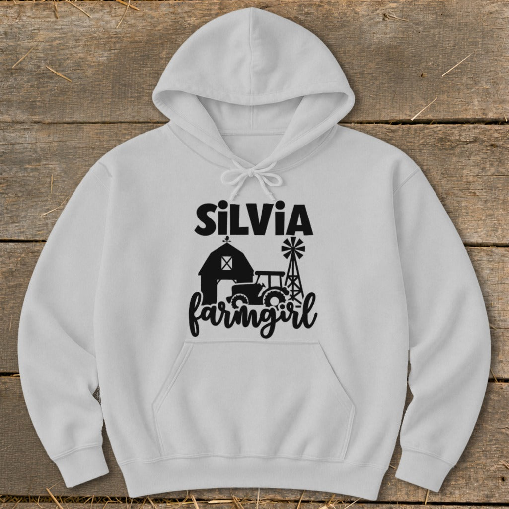 White hoodie with black "SILVIA farmgirl" text and farm graphic.