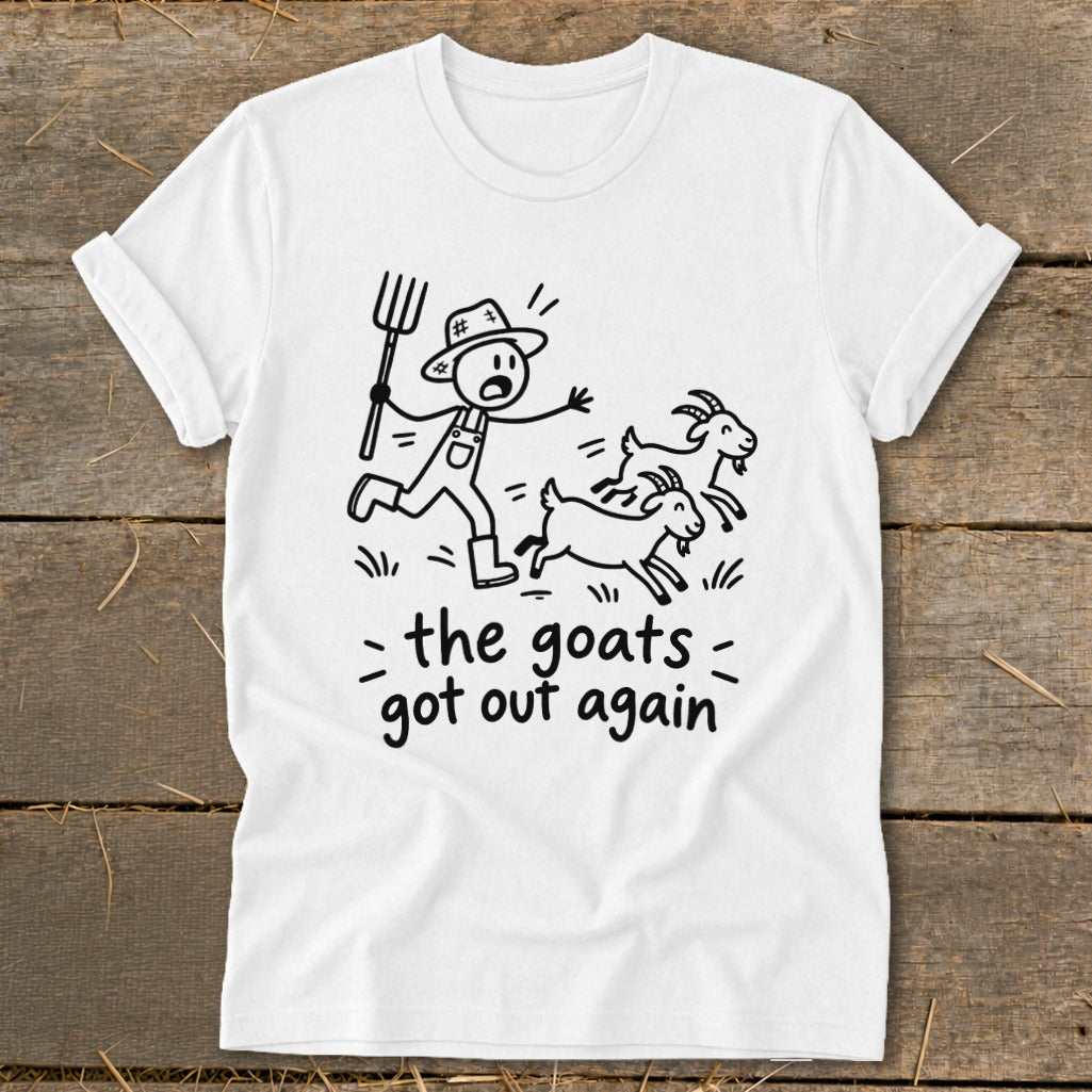 White t-shirt with stick figure farmer chasing three goats, text "the goats got out again".