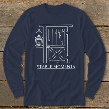 Navy long sleeve shirt with white line art of a stable door and lantern, and text "STABLE MOMENTS".