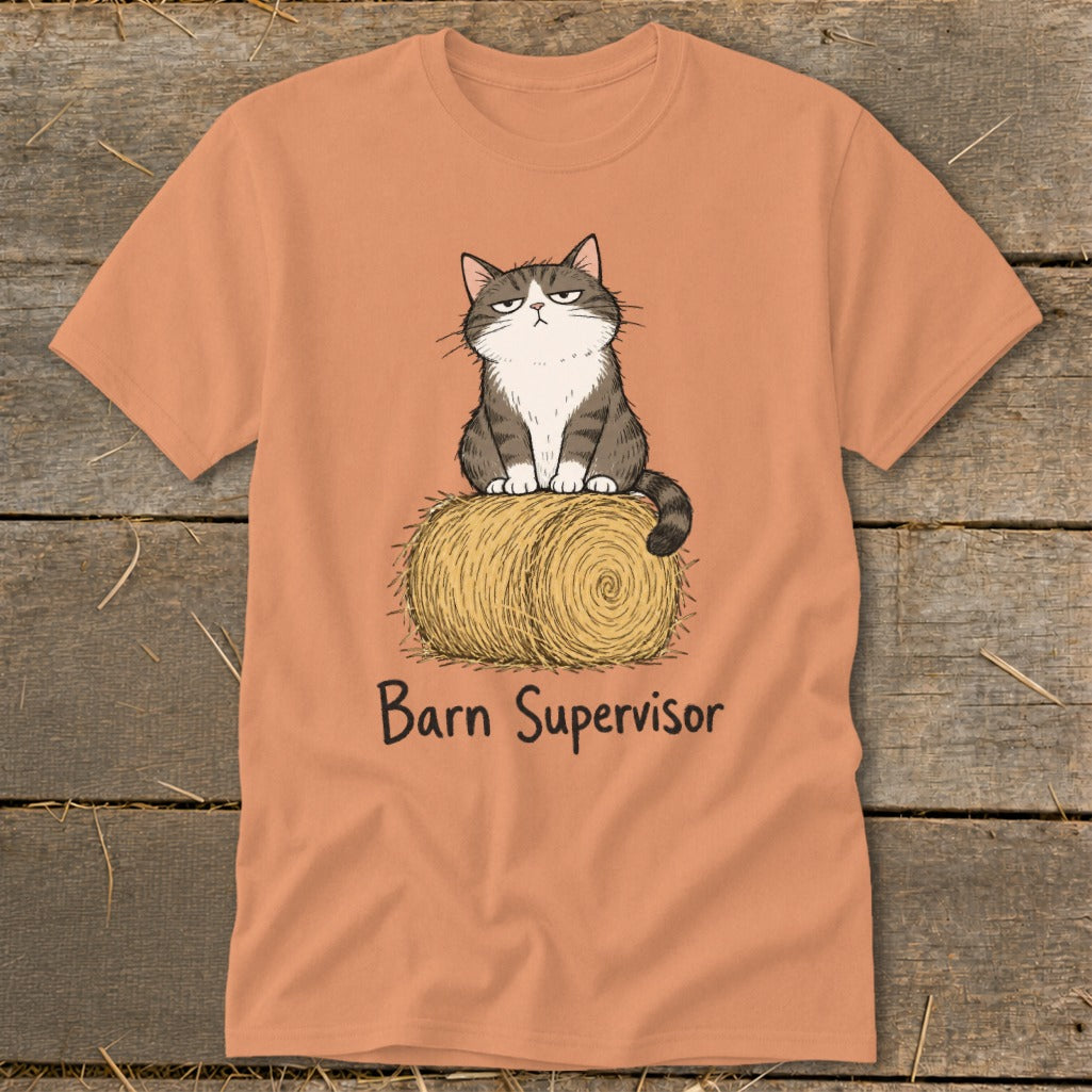 Cat sitting on hay bale with "Barn Supervisor" text on orange t-shirt.