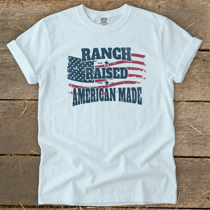 White t-shirt with distressed American flag graphic and text "Ranch Raised American Made."