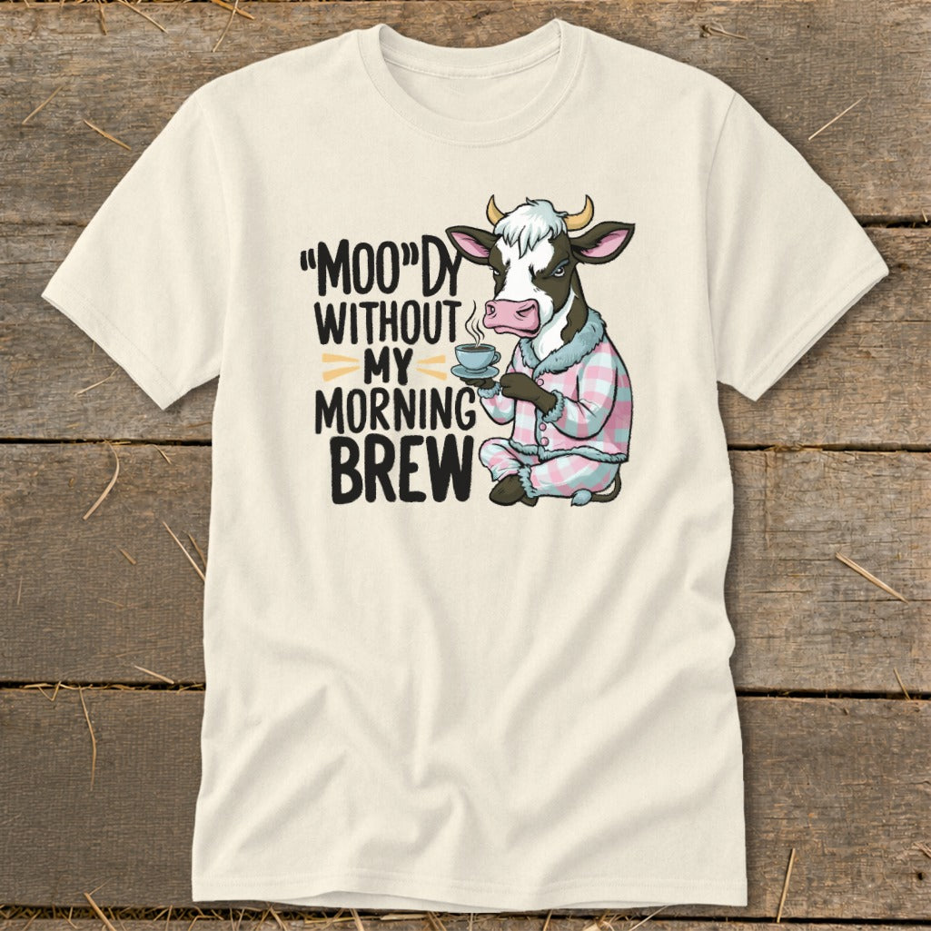 T-shirt graphic of a cow in pajamas holding a coffee cup with text: "Moo"dy without my morning brew.