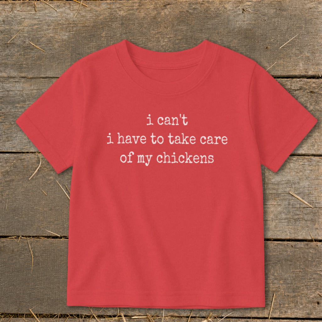 Red t-shirt with white text: "i can't i have to take care of my chickens"