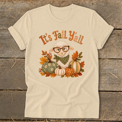 Cream t-shirt with graphic of a sheep wearing glasses and bandana among pumpkins and fall leaves.