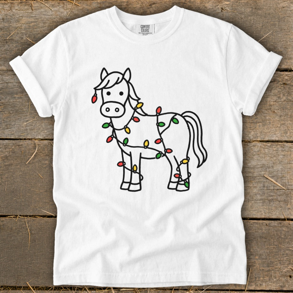 White t-shirt with a line drawing of a horse wrapped in colorful Christmas lights.