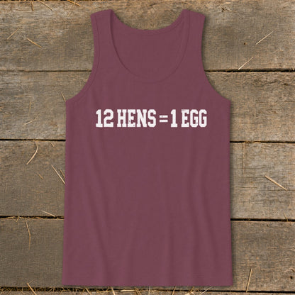 A maroon tank top with white text that reads 12 HENS = 1 EGG, laid flat on a rustic wooden background.