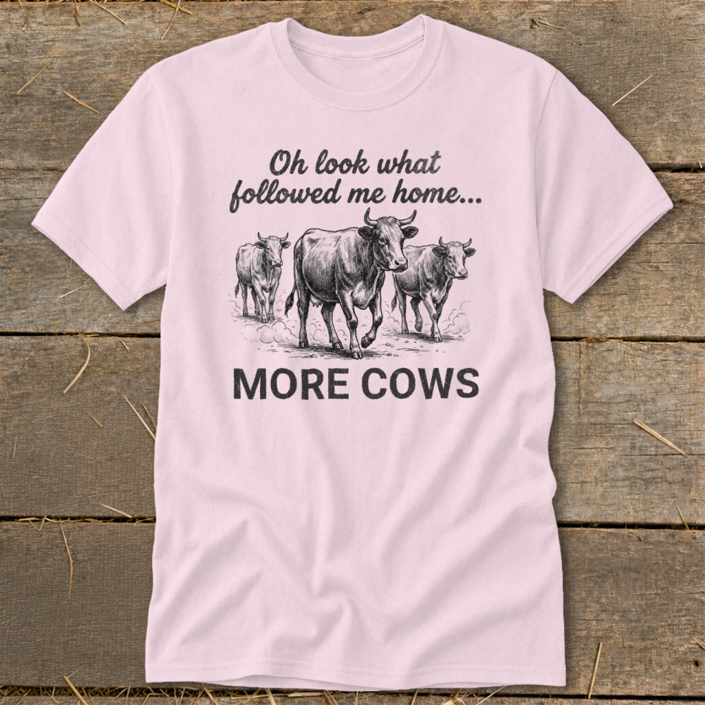Pink t-shirt with three cows and text "Oh look what followed me home... MORE COWS".