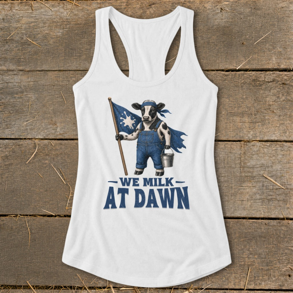 Cow wearing overalls and a cape, holding a flag and bucket, with "WE MILK AT DAWN" text.