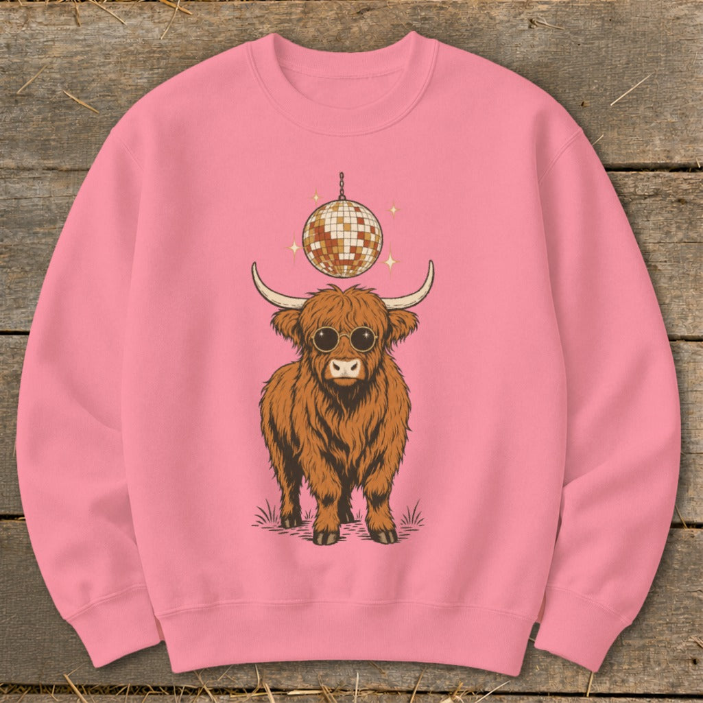 Pink sweatshirt with a fluffy highland cow wearing sunglasses under a disco ball.