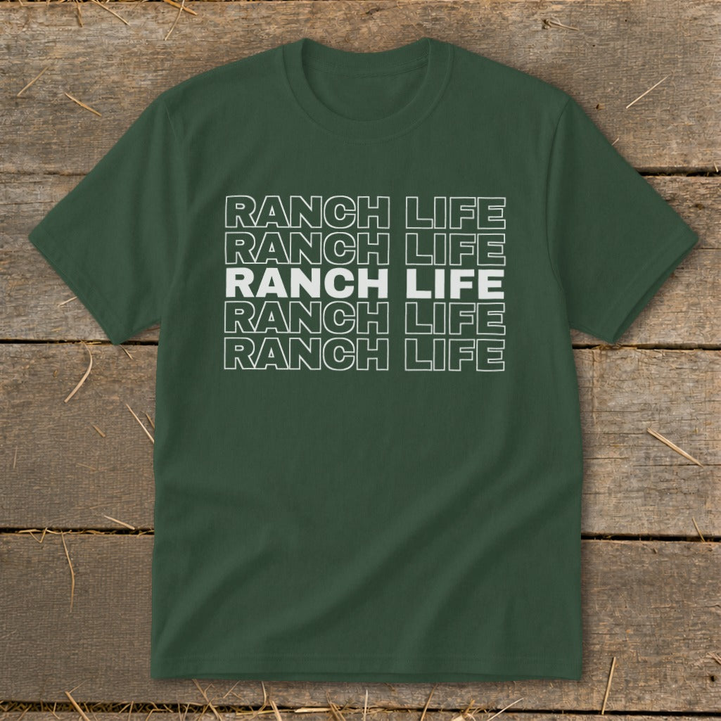 Dark green t-shirt featuring stacked white outline text that reads RANCH LIFE against a wooden background.