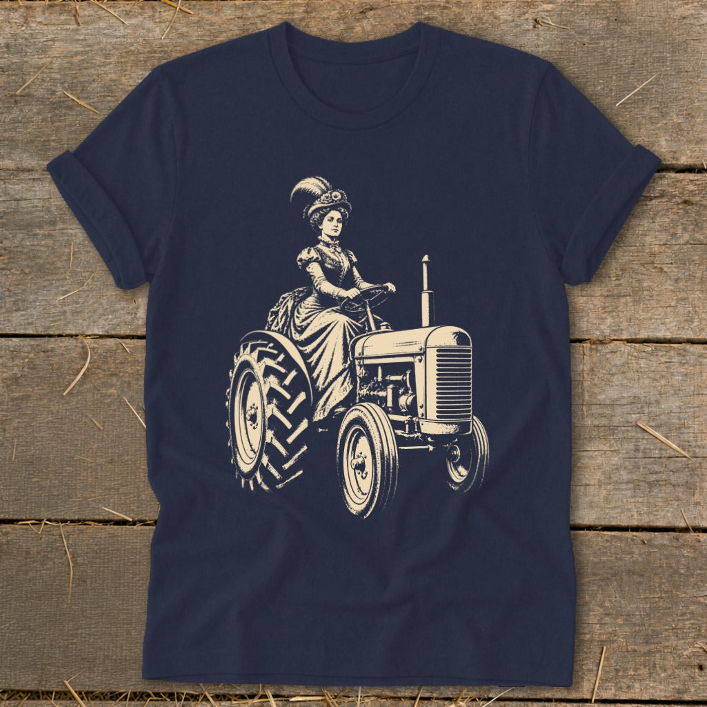 Cream line art of woman in vintage dress driving a tractor on navy shirt.