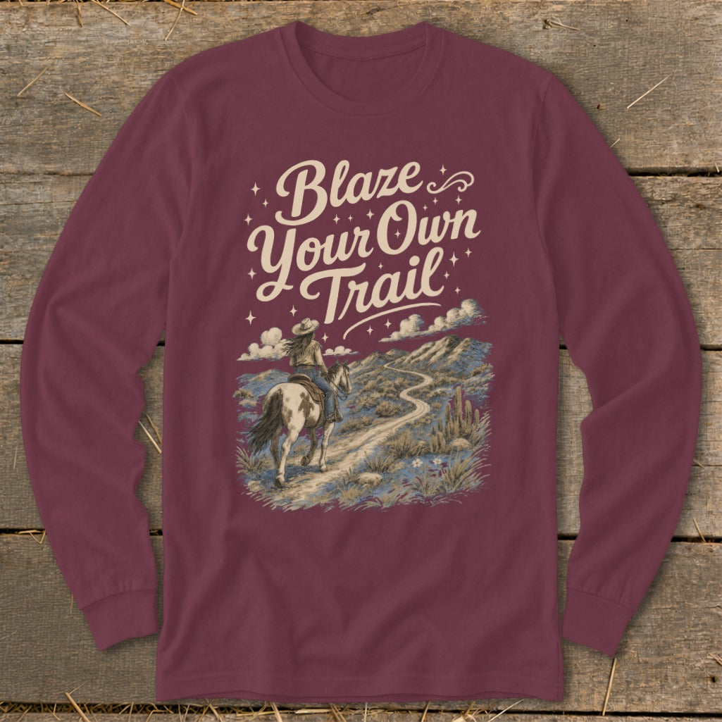 Maroon long-sleeve shirt with "Blaze Your Own Trail" text and desert landscape art.
