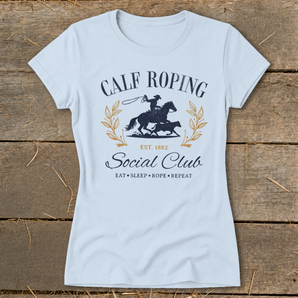 Light blue t-shirt with Calf Roping Social Club graphic and rodeo imagery.