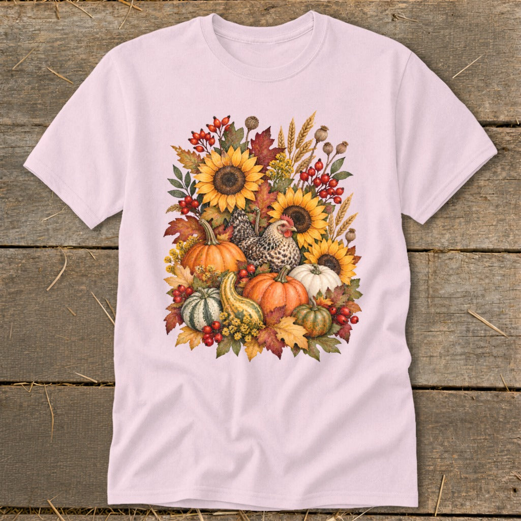 Pink t-shirt with a fall harvest graphic featuring sunflowers, pumpkins, gourds, and a chicken.