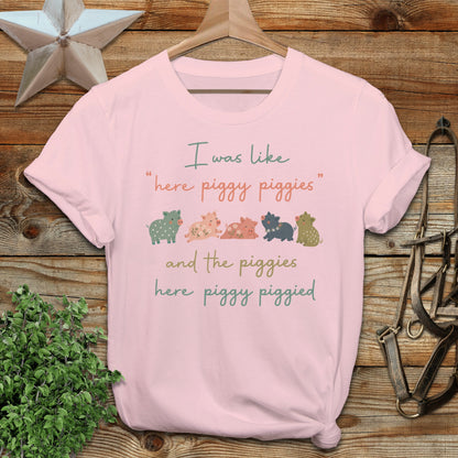 Pink t-shirt with "I was like 'here piggy piggies' and the piggies here piggy piggied" text.