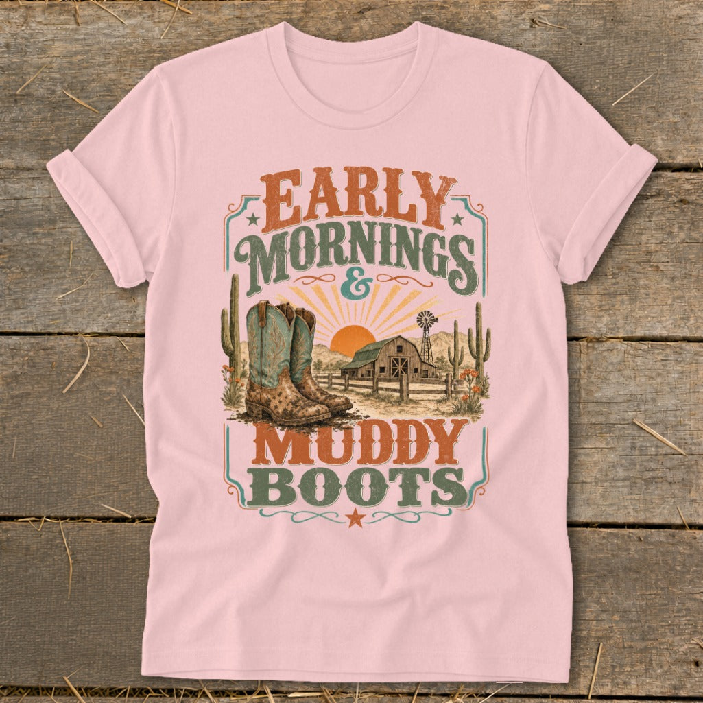 Pink t-shirt with "Early Mornings & Muddy Boots" graphic featuring cowboy boots, barn, and sunset.