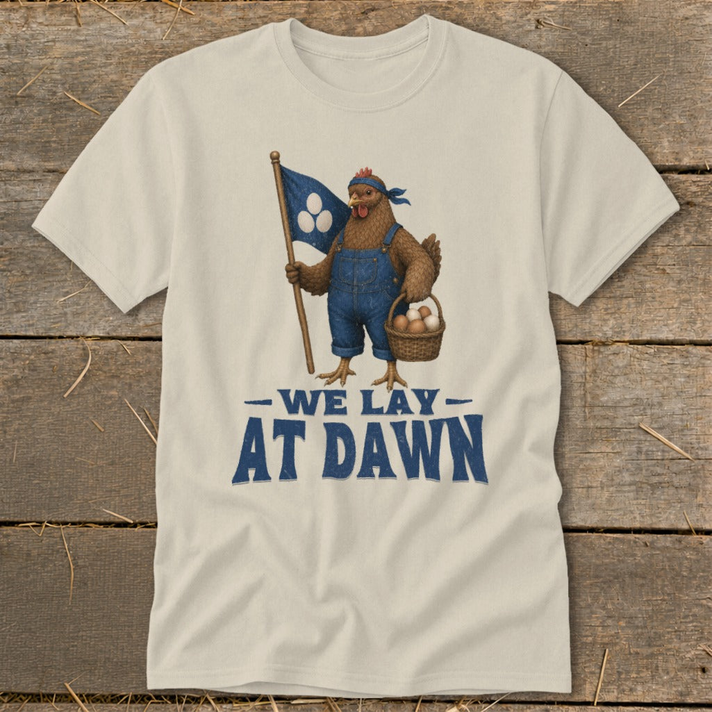 Chicken wearing overalls holding a flag and basket of eggs, text reads "WE LAY AT DAWN".