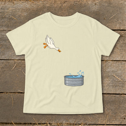 White duck jumping into a galvanized metal tub with splashing water.