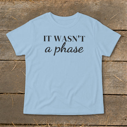 Light blue t-shirt with black text "IT WASN'T a phase".