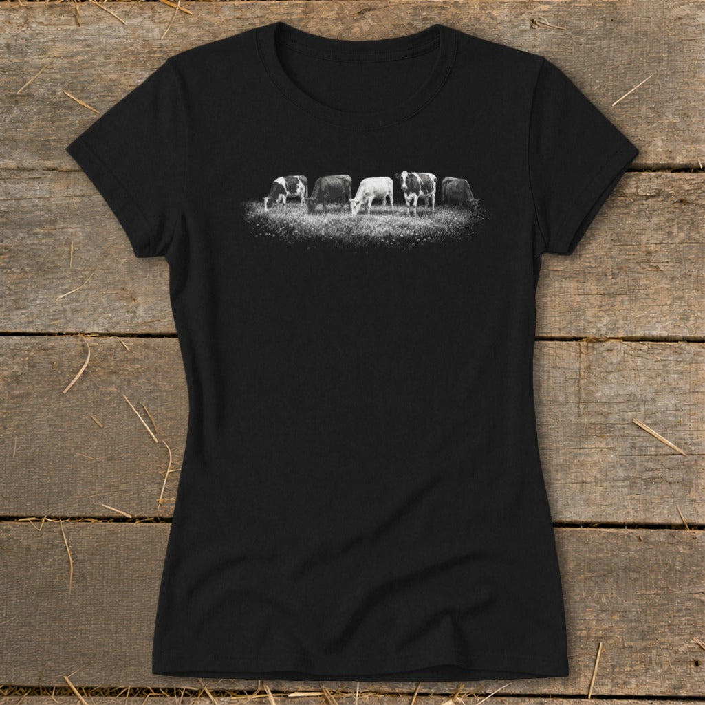Black t-shirt with a black and white graphic of five cows grazing in a field.